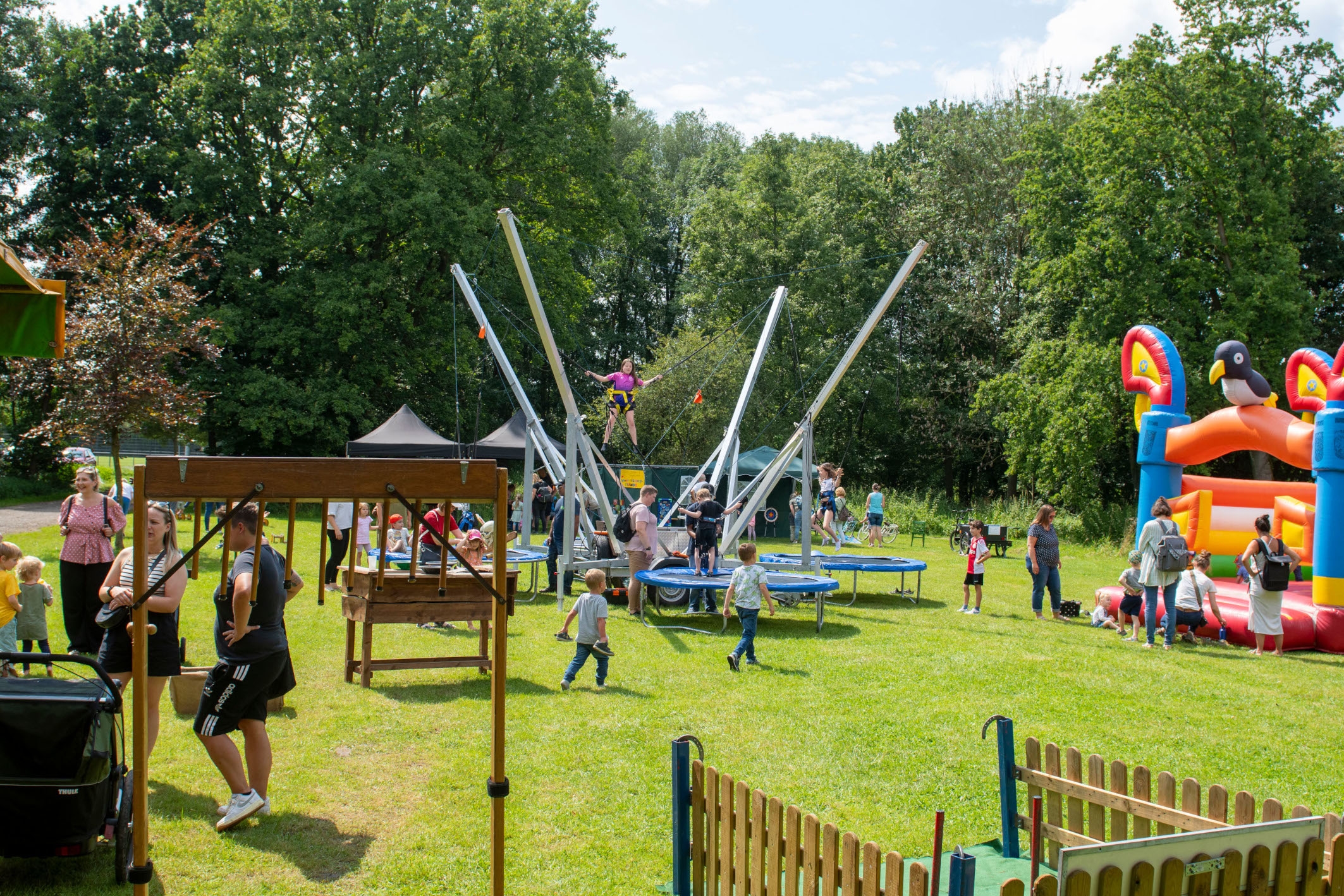 Children playing on bouncy castles and trampolines